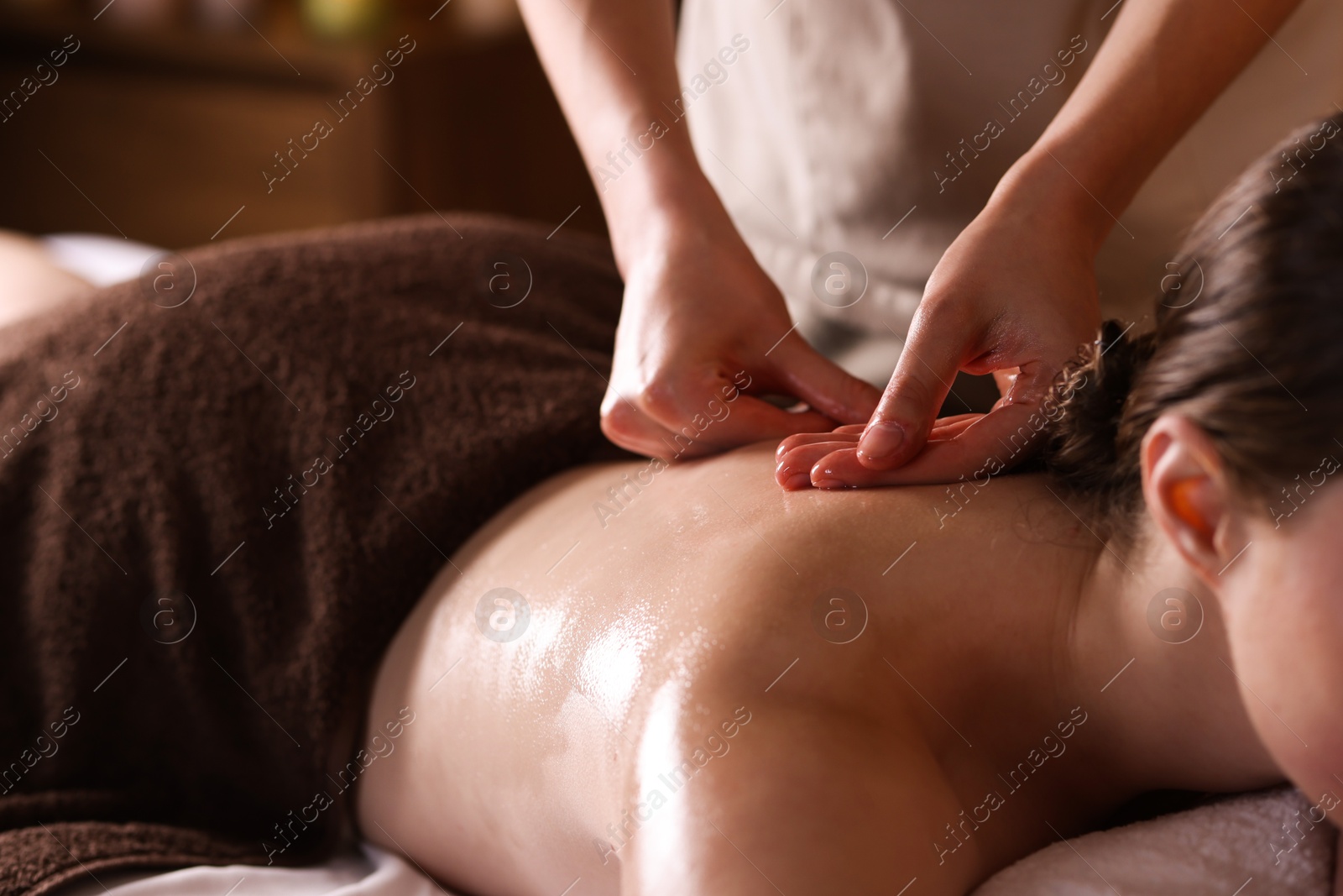 Woman receiving back massage with oil in spa salon, closeup Photo of Woman receiving back massage with oil in spa salon, closeup