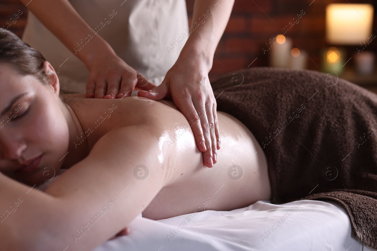 Woman receiving back massage with oil in spa salon, closeup Photo of Woman receiving back massage with oil in spa salon, closeup