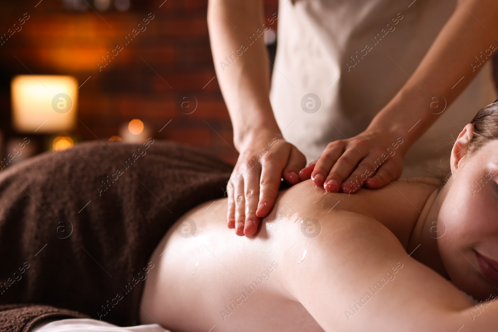 Woman receiving back massage with oil in spa salon, closeup Photo of Woman receiving back massage with oil in spa salon, closeup