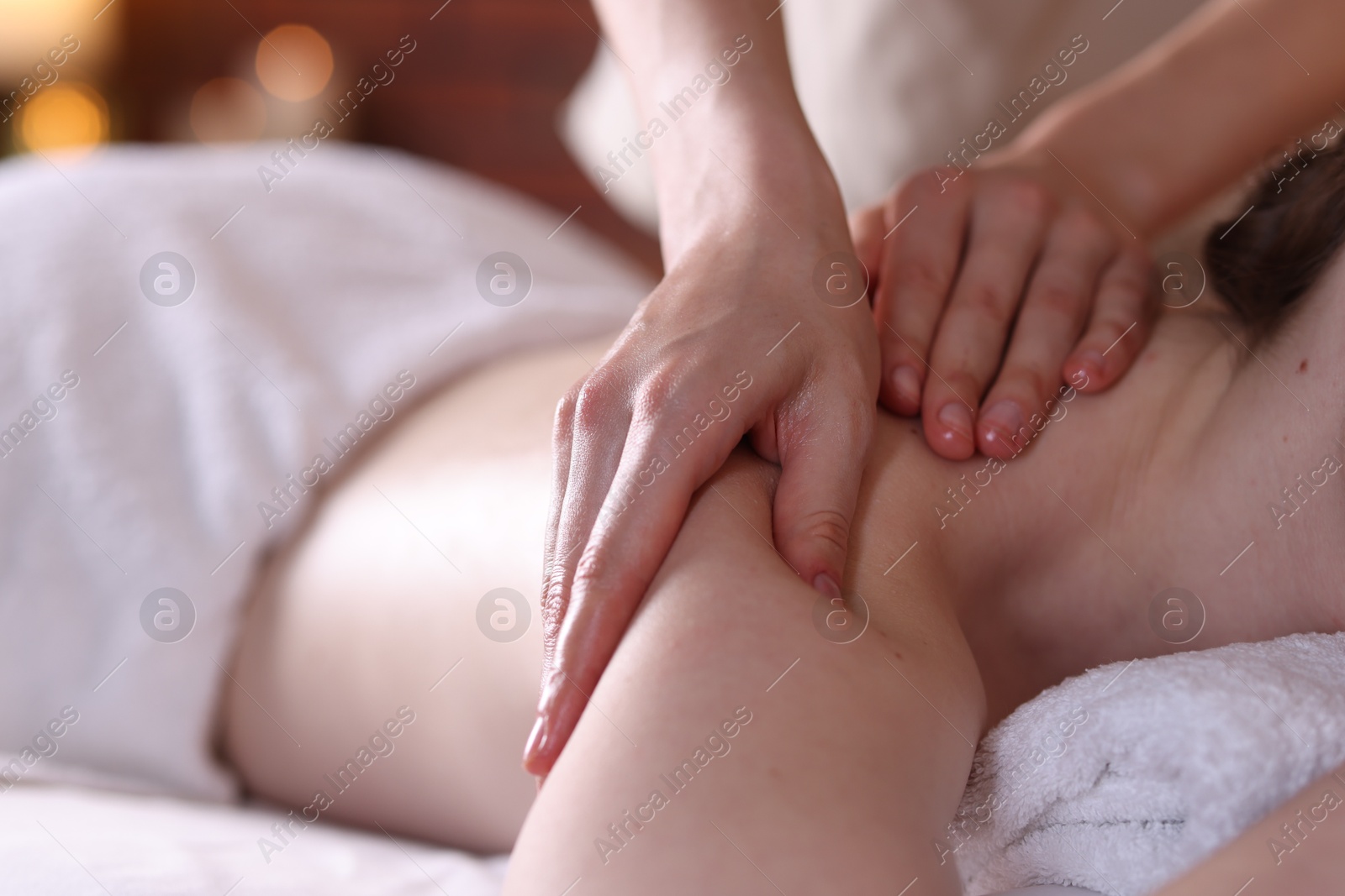 Woman receiving back massage with oil in spa salon, closeup Photo of Woman receiving back massage with oil in spa salon, closeup