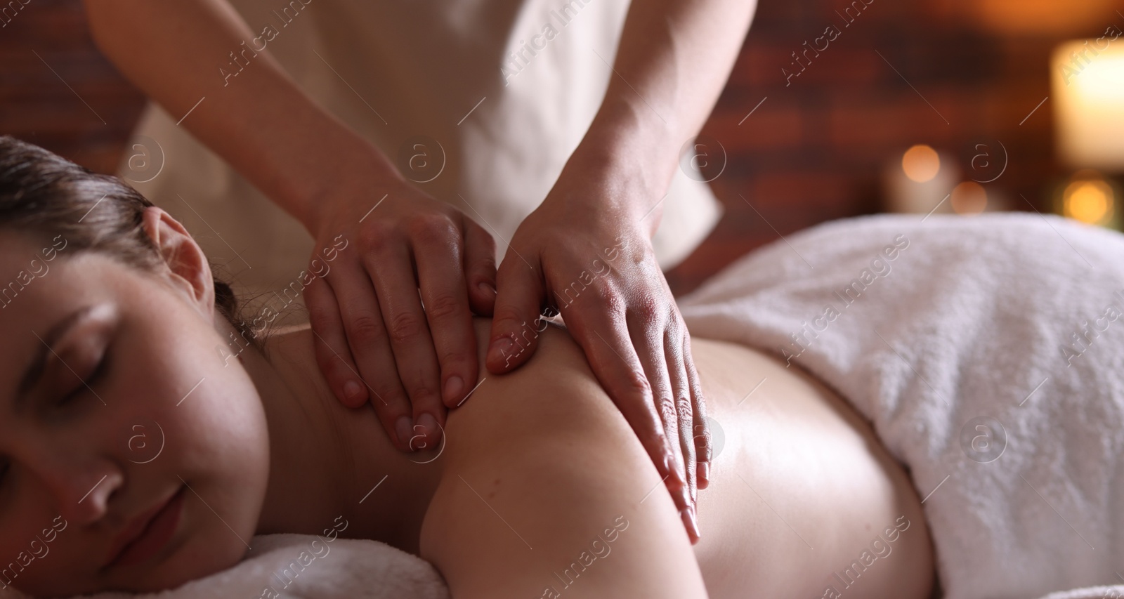Woman receiving back massage with oil in spa salon, closeup Photo of Woman receiving back massage with oil in spa salon, closeup