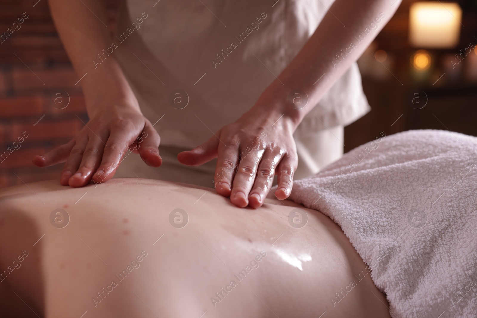 Woman receiving back massage with oil in spa salon, closeup Photo of Woman receiving back massage with oil in spa salon, closeup