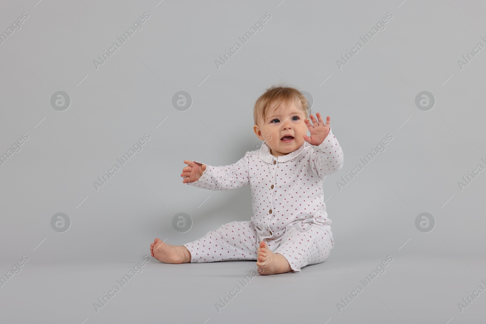 Cute little baby on light grey background Photo of Cute little baby on light grey background