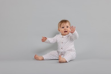 Photo of Cute little baby on light grey background