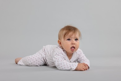 Photo of Cute little baby on light grey background