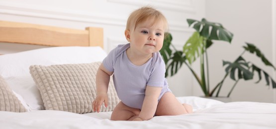 Photo of Cute little baby on bed at home