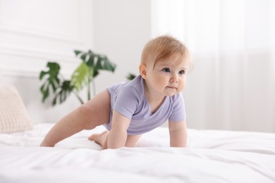 Photo of Cute little baby on bed at home