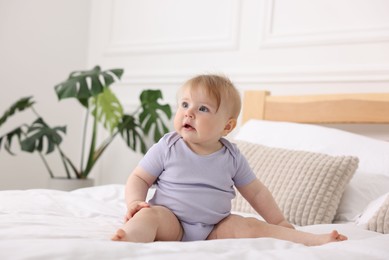 Photo of Cute little baby on bed at home