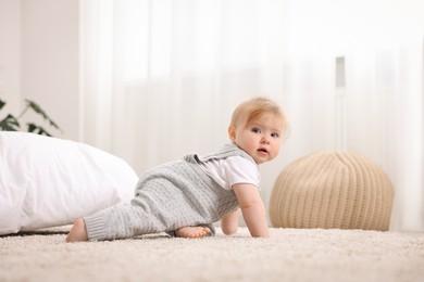 Photo of Cute little baby crawling on floor at home