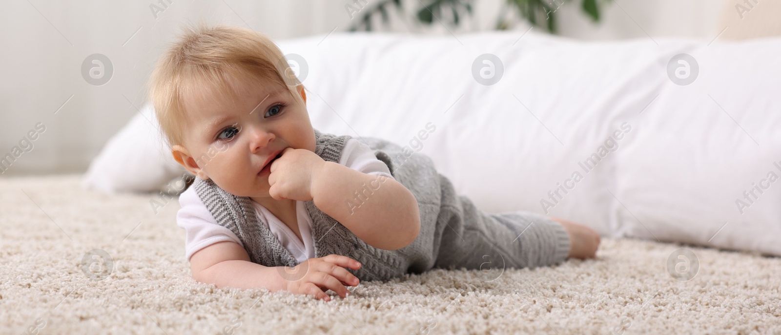 Cute little baby near bed at home Photo of Cute little baby near bed at home