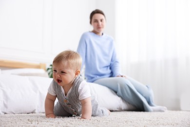 Photo of Mother and her little baby at home, selective focus
