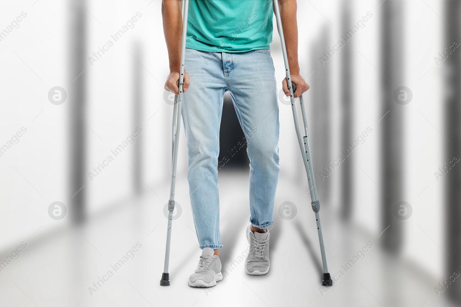 Man with axillary crutches in hospital, closeup Image of Man with axillary crutches in hospital, closeup