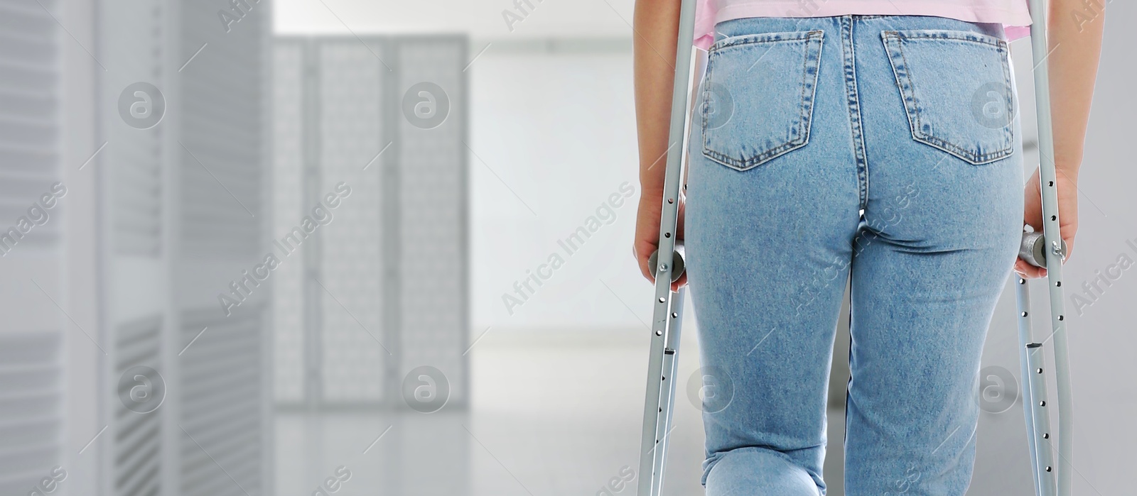 Woman with axillary crutches in hospital, closeup. Banner design Image of Woman with axillary crutches in hospital, closeup. Banner design