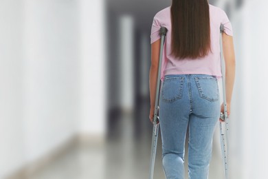 Image of Woman with axillary crutches in hospital, closeup. Space for text