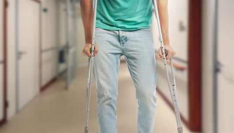Image of Man with axillary crutches in hospital, closeup. Banner design