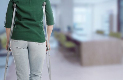 Image of Woman with axillary crutches in hospital, closeup. Space for text