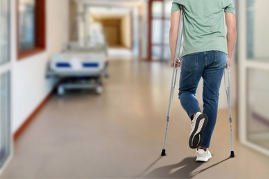 Image of Man with axillary crutches in hospital, closeup. Space for text