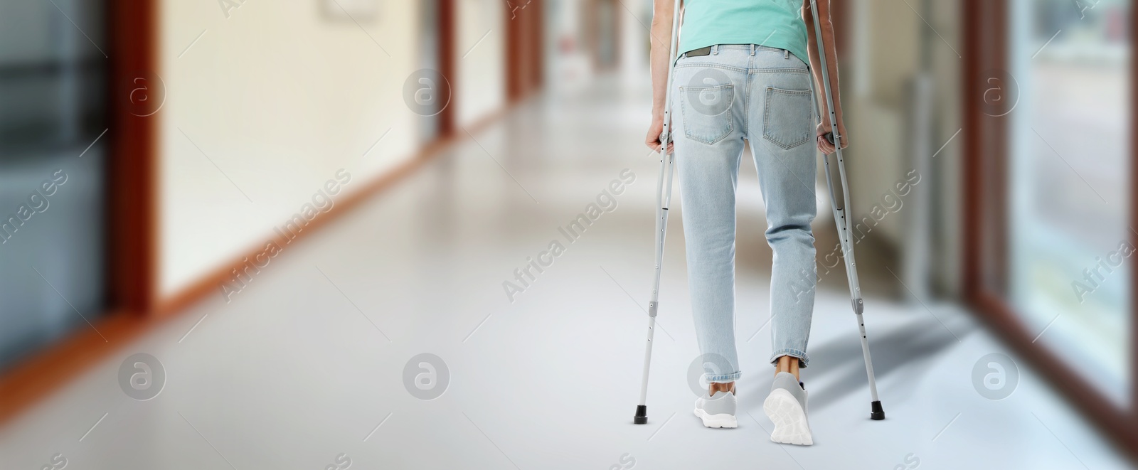 Man with axillary crutches in hospital, closeup. Banner design Image of Man with axillary crutches in hospital, closeup. Banner design