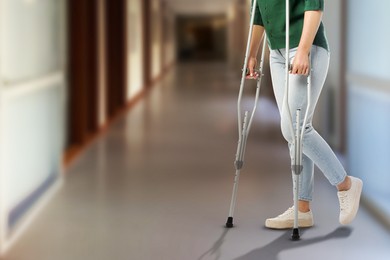 Image of Woman with axillary crutches in hospital, closeup. Space for text