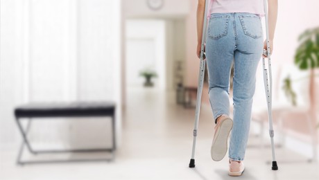 Image of Woman with axillary crutches in hospital, closeup. Banner design