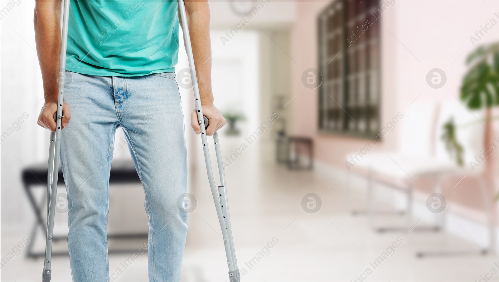 Man with axillary crutches in hospital, closeup. Banner design Image of Man with axillary crutches in hospital, closeup. Banner design