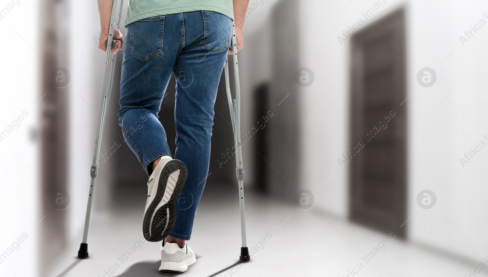 Man with axillary crutches in hospital, closeup. Banner design Image of Man with axillary crutches in hospital, closeup. Banner design