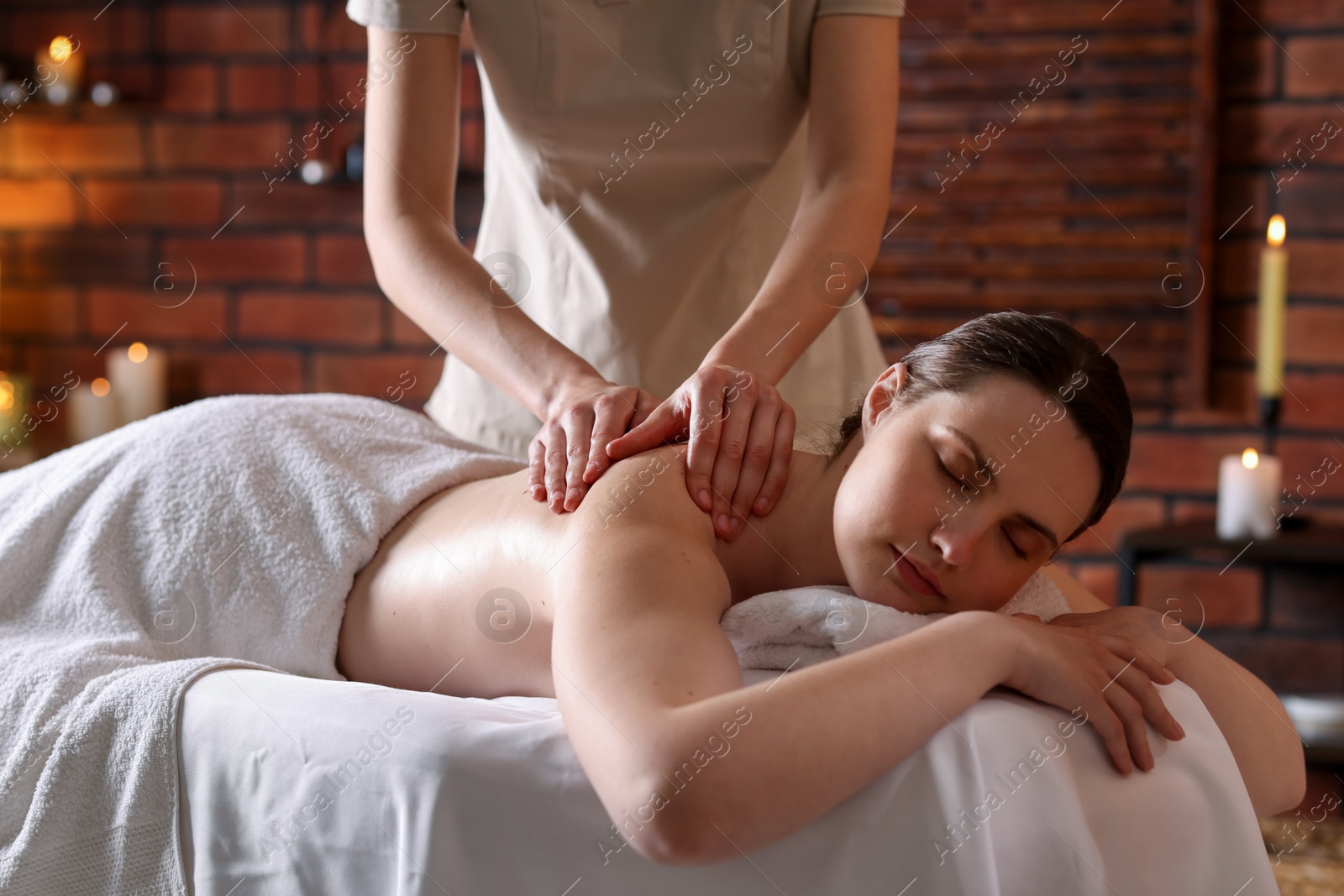 Woman receiving back massage with oil in spa salon Photo of Woman receiving back massage with oil in spa salon