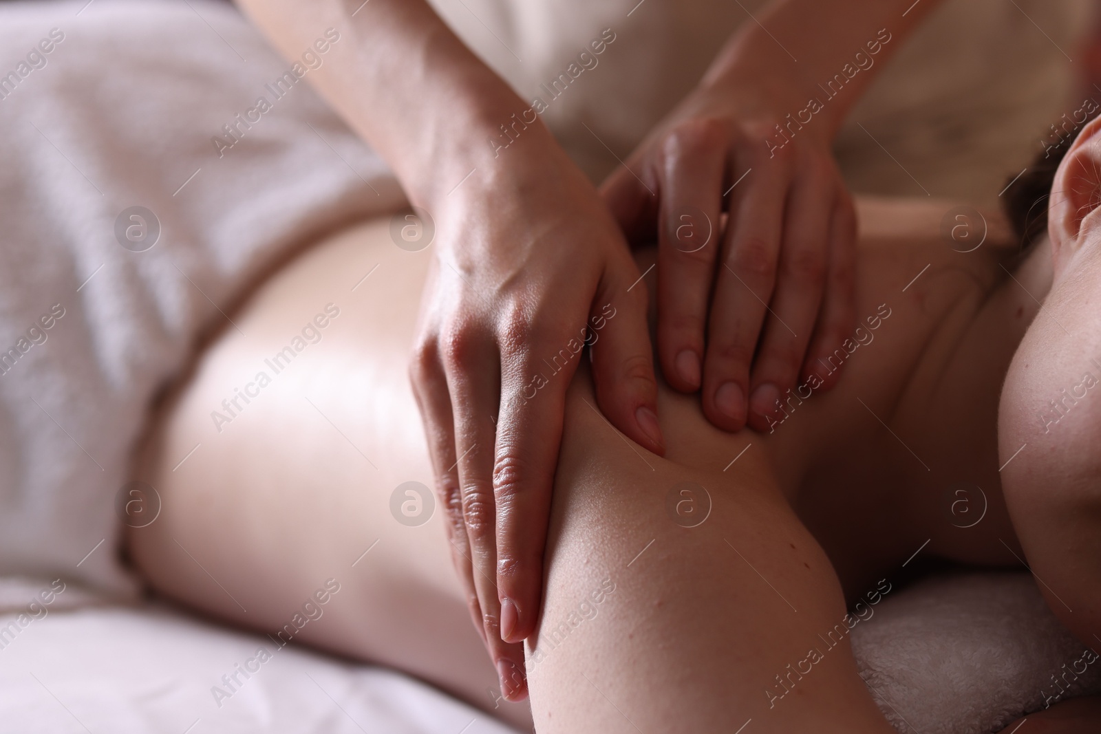 Woman receiving back massage with oil in spa salon, closeup Photo of Woman receiving back massage with oil in spa salon, closeup