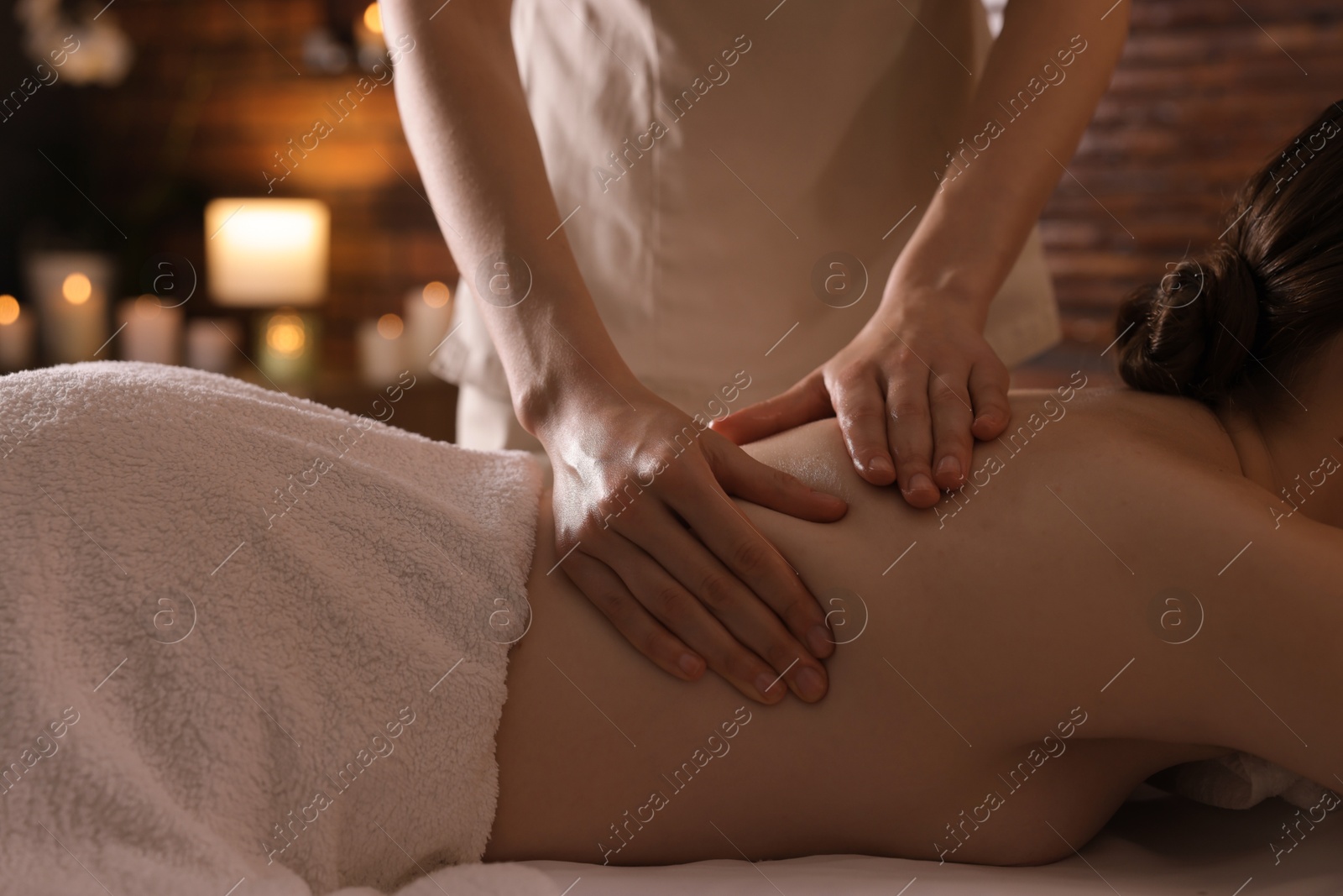 Woman receiving back massage with oil in spa salon, closeup Photo of Woman receiving back massage with oil in spa salon, closeup