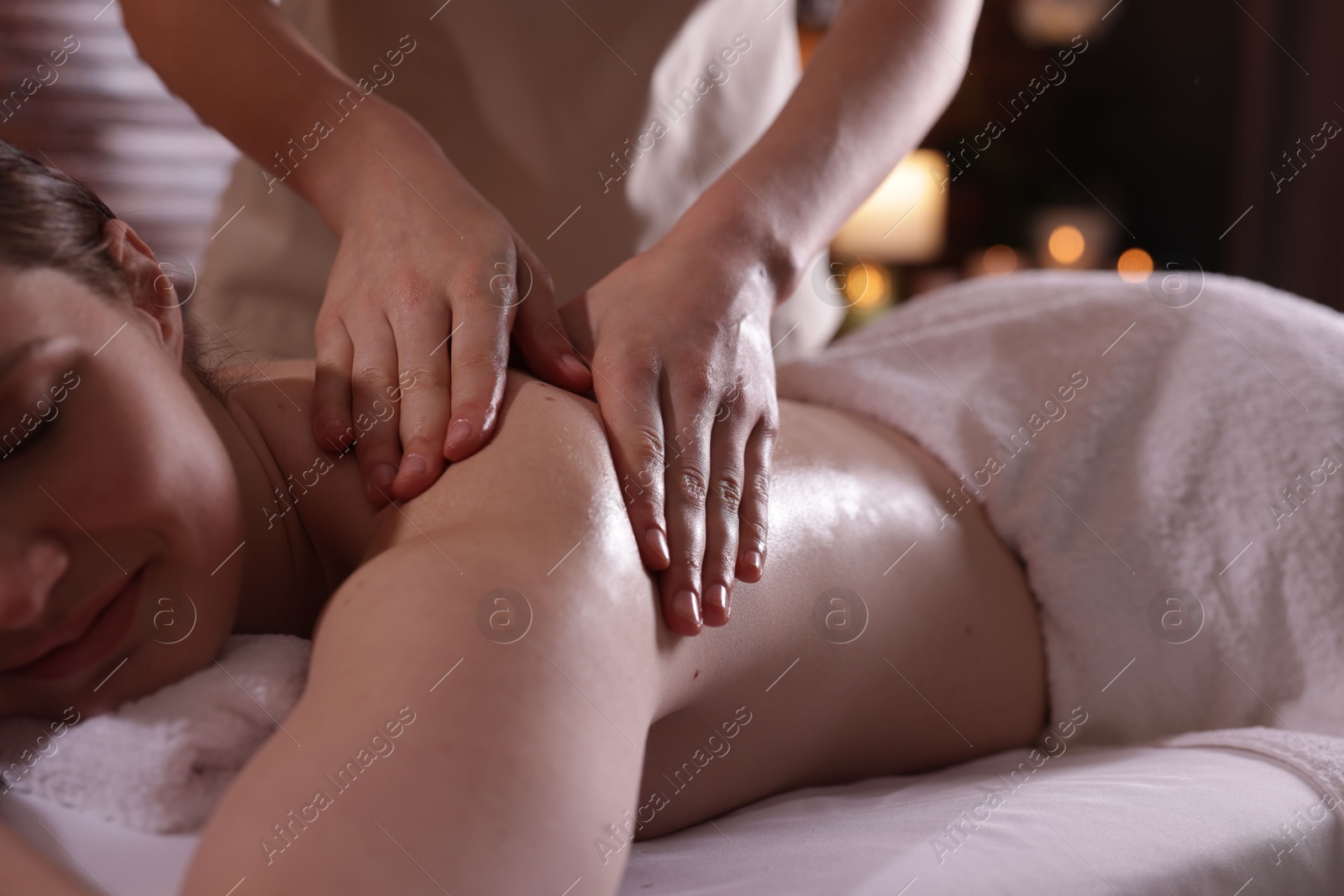 Woman receiving back massage with oil in spa salon, closeup Photo of Woman receiving back massage with oil in spa salon, closeup