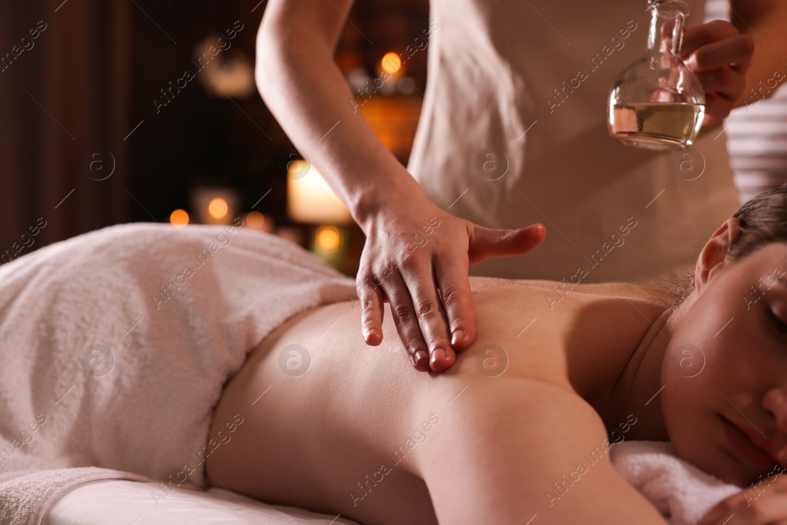 Woman receiving back massage with oil in spa salon, closeup Photo of Woman receiving back massage with oil in spa salon, closeup