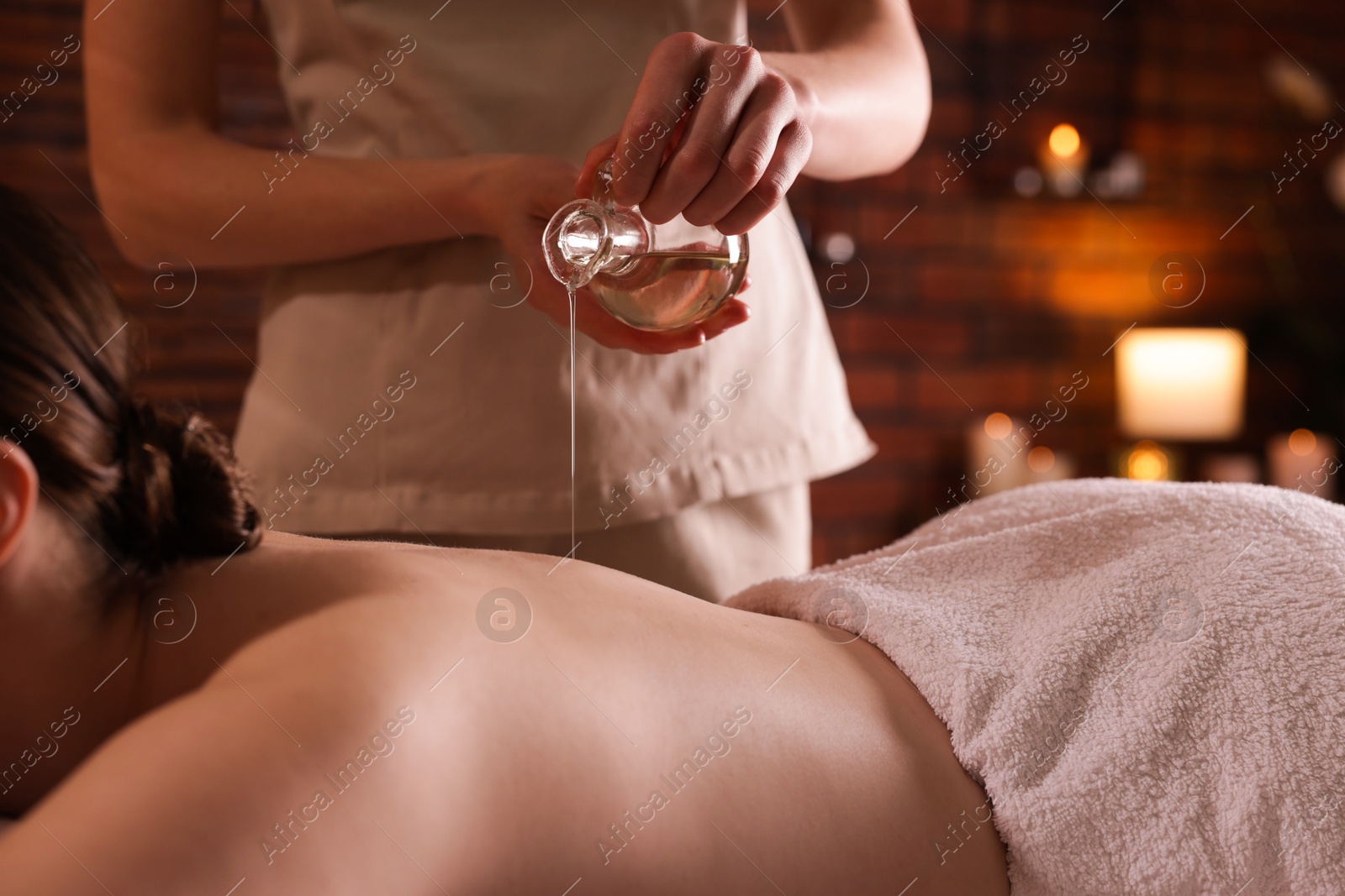 Woman receiving back massage with oil in spa salon, closeup Photo of Woman receiving back massage with oil in spa salon, closeup