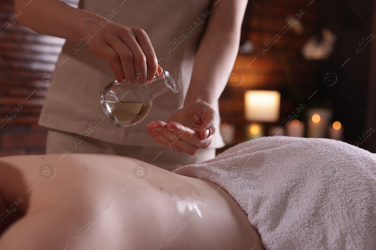 Woman receiving back massage with oil in spa salon, closeup Photo of Woman receiving back massage with oil in spa salon, closeup