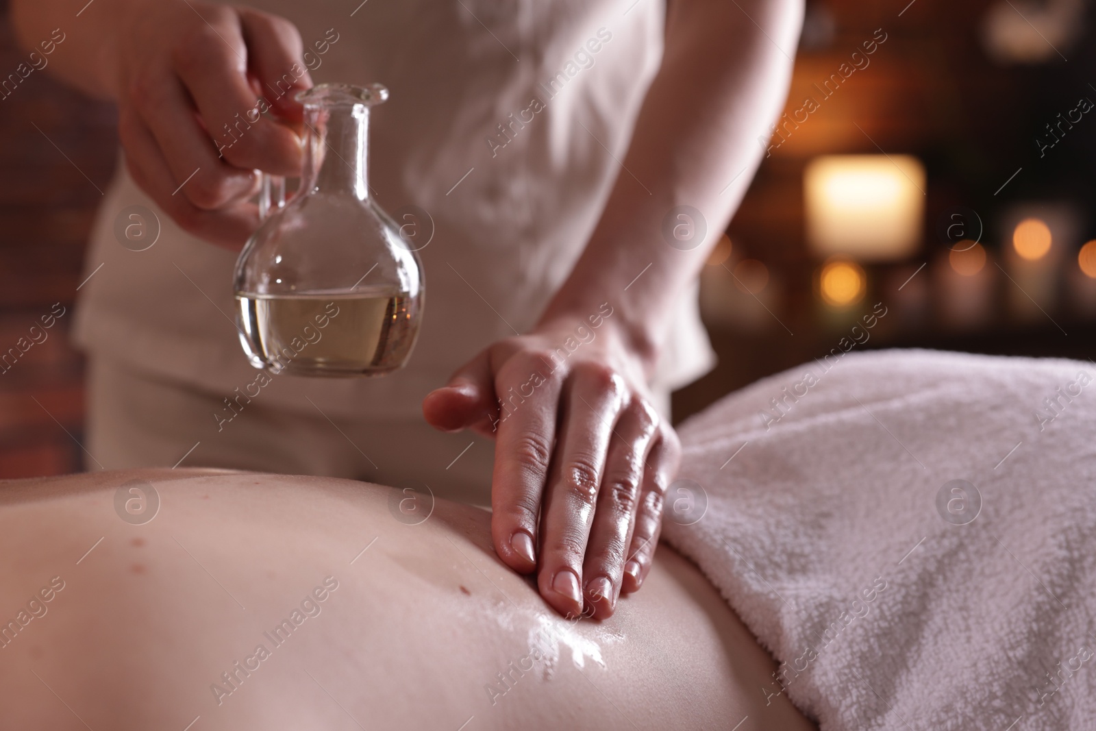 Woman receiving back massage with oil in spa salon, closeup Photo of Woman receiving back massage with oil in spa salon, closeup