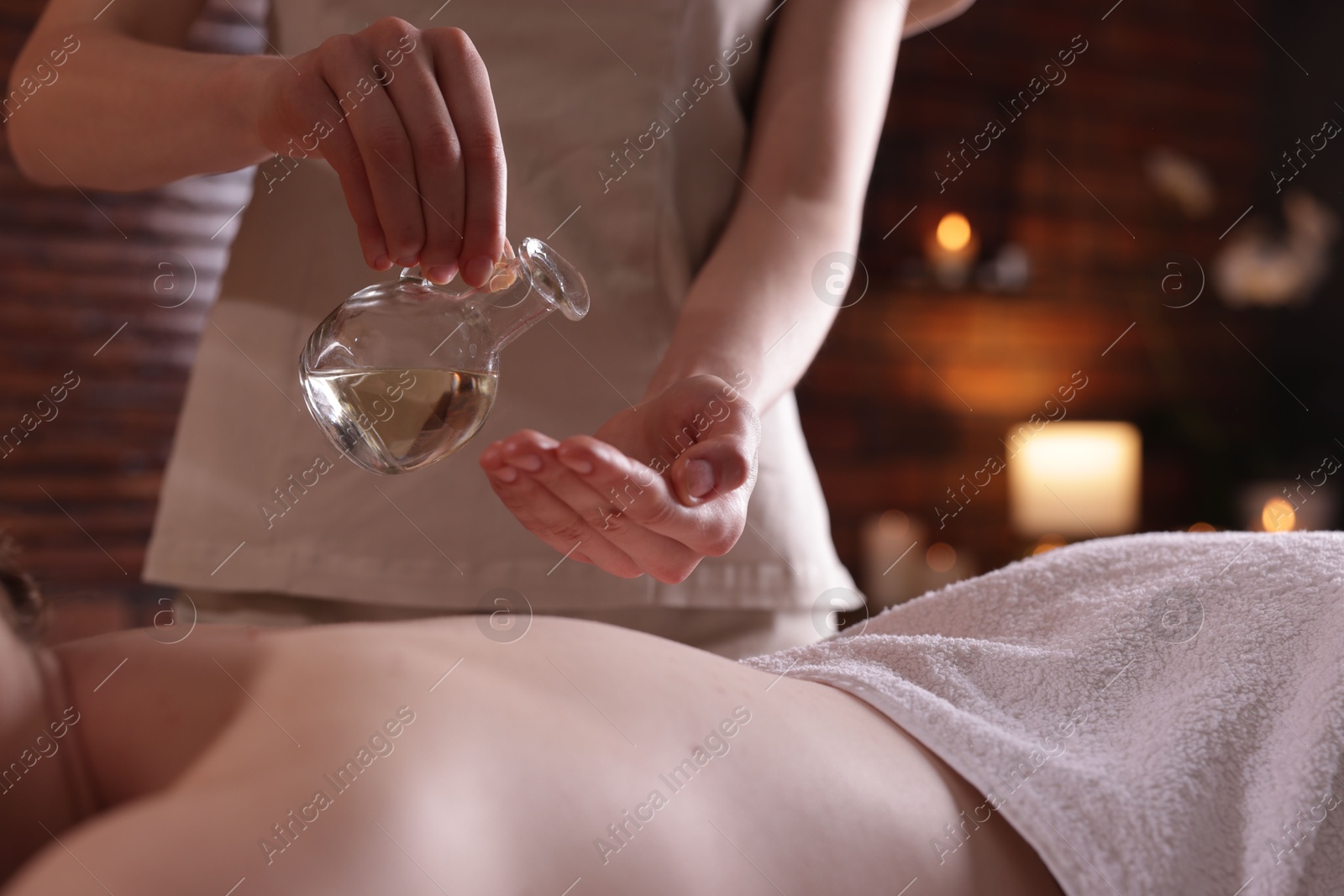 Woman receiving back massage with oil in spa salon, closeup Photo of Woman receiving back massage with oil in spa salon, closeup