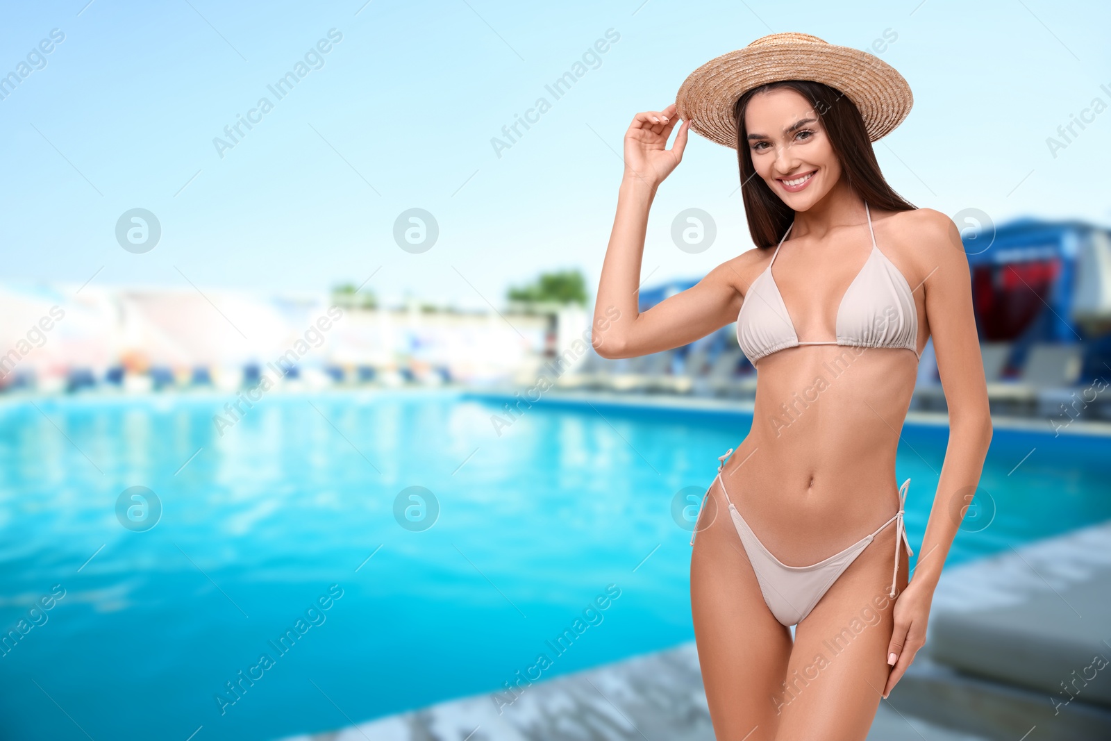 Attractive woman in swimsuit near outdoor swimming pool. Vacation at sea resort Image of Attractive woman in swimsuit near outdoor swimming pool. Vacation at sea resort