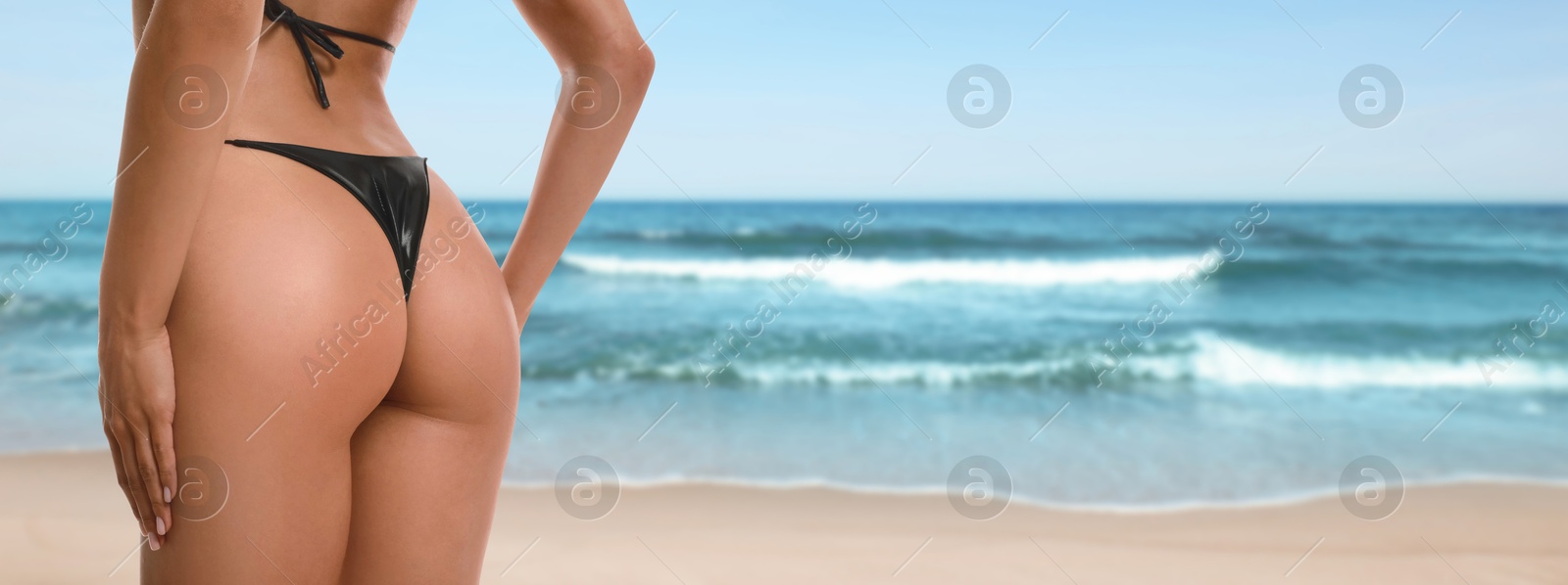 Pretty woman in swimsuit on beautiful beach, closeup. Banner design Image of Pretty woman in swimsuit on beautiful beach, closeup. Banner design