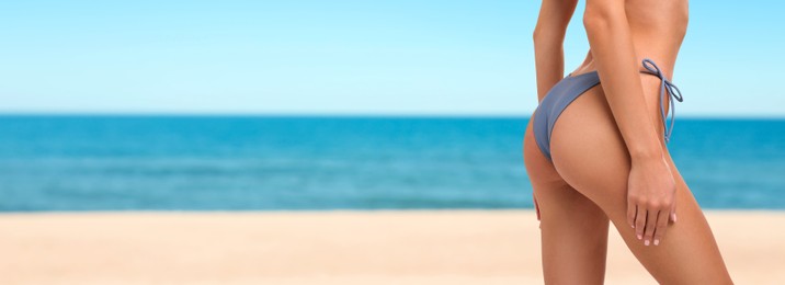 Image of Pretty woman in swimsuit on beautiful beach, closeup. Banner design