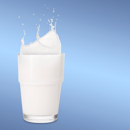 Image of Milk splashing out of glass on light blue background. Space for text