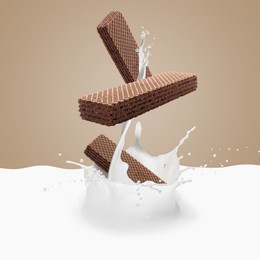 Image of Tasty crispy wafers falling into splashing milk against pale brown background