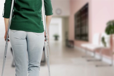 Image of Woman with axillary crutches in hospital, closeup. Space for text