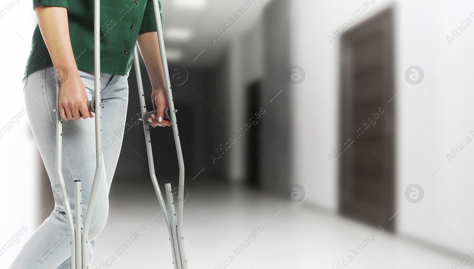Woman with axillary crutches in hospital, closeup. Banner design Image of Woman with axillary crutches in hospital, closeup. Banner design