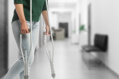 Image of Woman with axillary crutches in hospital, closeup. Space for text