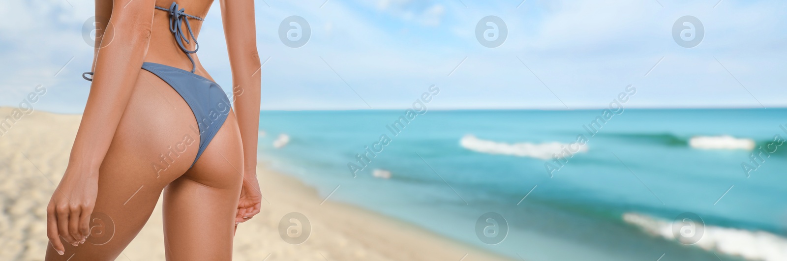 Attractive woman in swimsuit on beautiful tropical beach, closeup. Banner design Image of Attractive woman in swimsuit on beautiful tropical beach, closeup. Banner design
