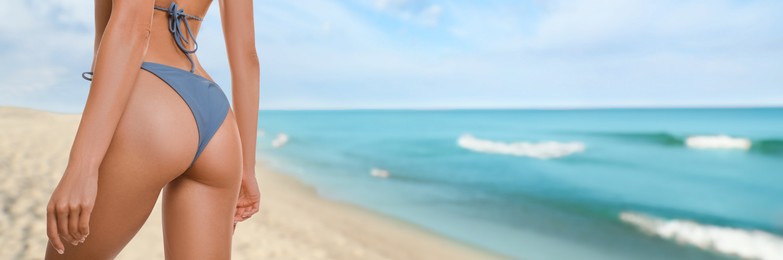 Image of Attractive woman in swimsuit on beautiful tropical beach, closeup. Banner design
