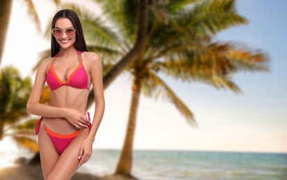 Image of Attractive woman in swimsuit on beautiful beach. Vacation at sea resort