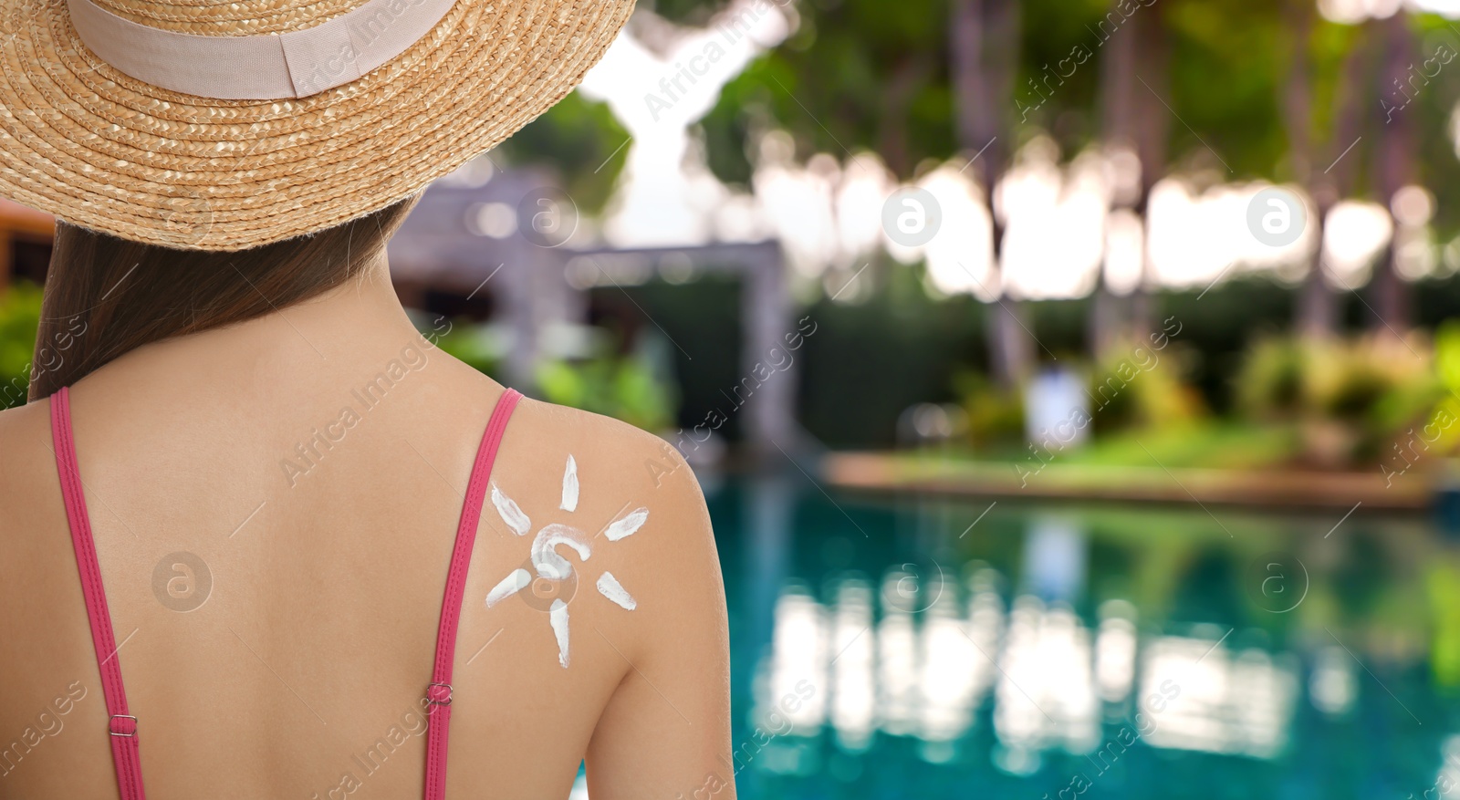 Woman with sun image made of sunblock cream on her skin near outdoor swimming pool, closeup. Banner design Image of Woman with sun image made of sunblock cream on her skin near outdoor swimming pool, closeup. Banner design