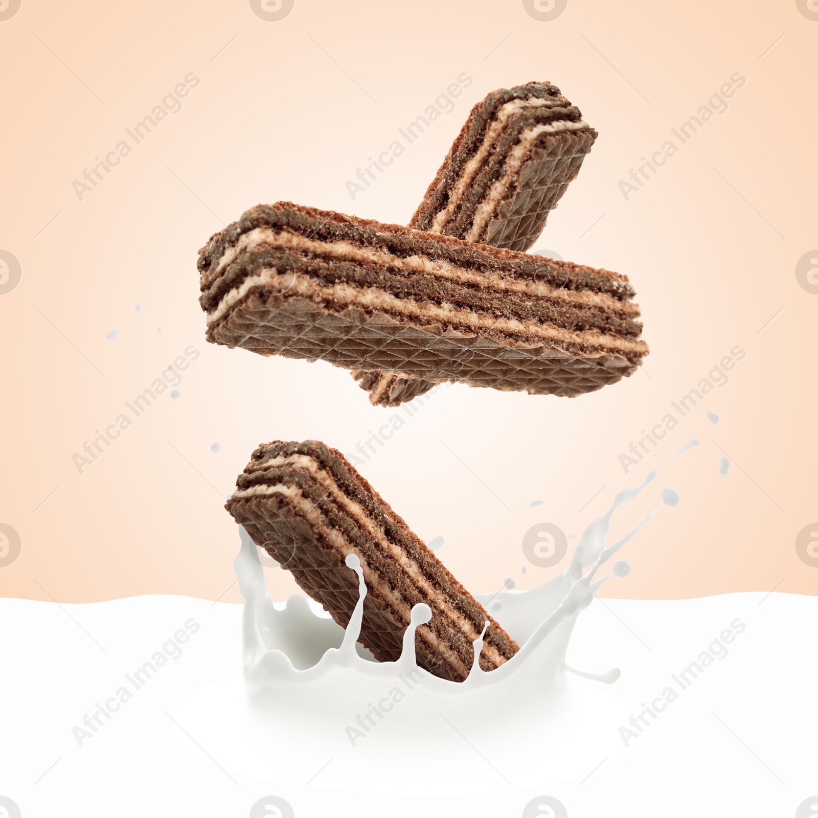 Tasty crispy wafers falling into splashing milk against pink beige background Image of Tasty crispy wafers falling into splashing milk against pink beige background