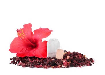 Image of Red hibiscus flower, tea bag and dried calyces on white background