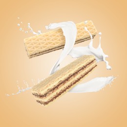 Image of Tasty crispy wafers and splashing milk on dark beige background